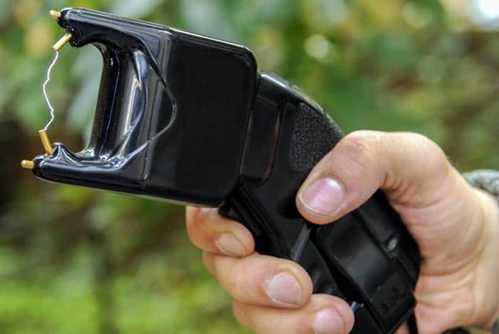 A man holding a stun gun, demonstrating its use for self defense